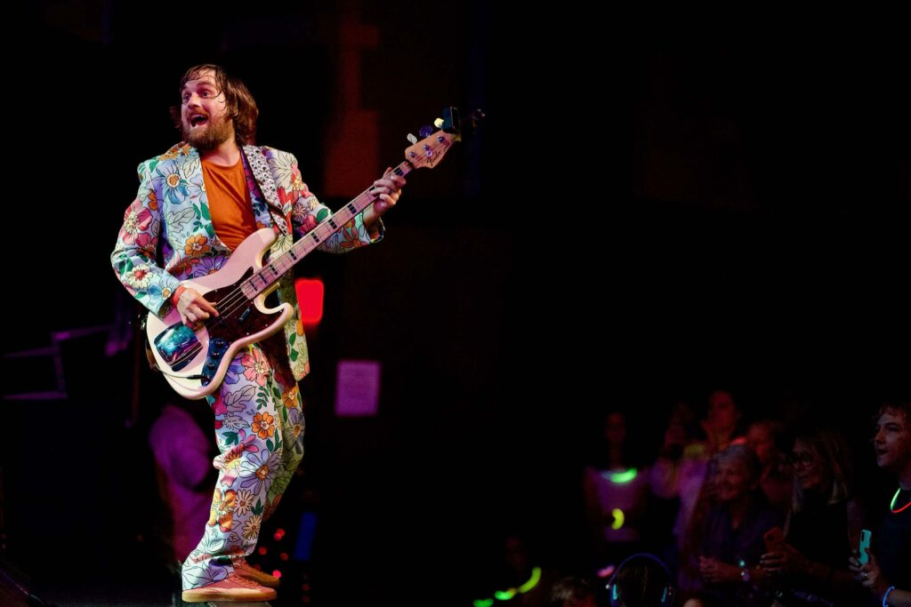 Brad smiling at Frostapalooza, wearing a bass and a loud suit